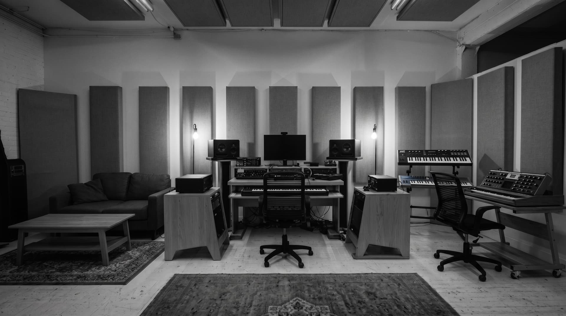 Control room at night with monitors and a mixing position in low, even light